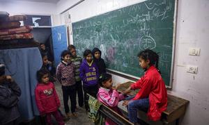 Children play in a classroom at a shelter located in Rafah city.