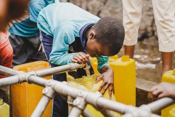 A child fills a container at a water tap installed by UNICEF in Kanyaruchinya near Goma, in the eastern DR Congo.