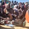 Displaced Sudanese people wait to receive food from the World Food Programme (WFP). (file)