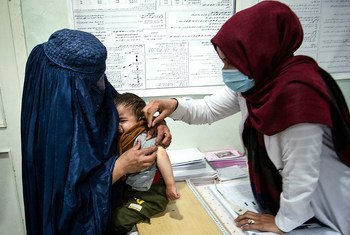 The Taliban de facto authorities have issued several orders rolling back the rights of women and girls in Afghan society. In this file photo, a health worker cares for a young boy in Parwan Province.