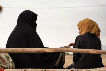 A woman and girl interact in rural in Yemen 
