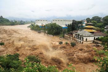 A swollen river surges through Kathmandu, Nepal's capital, after the heaviest rainfall in over 50 years.