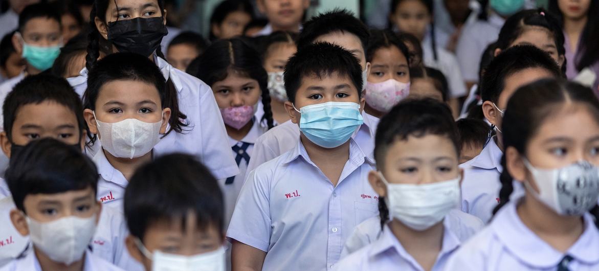 Students at a primary school in Bangkok wear masks during their morning lineup as air pollution levels soar.