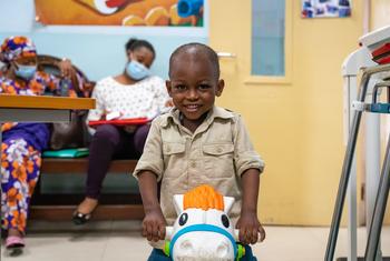 A two-year-old boy diagnosed with leukemia and treated with chemotherap plays while he waits to see a doctor at a hospital in Ghana.