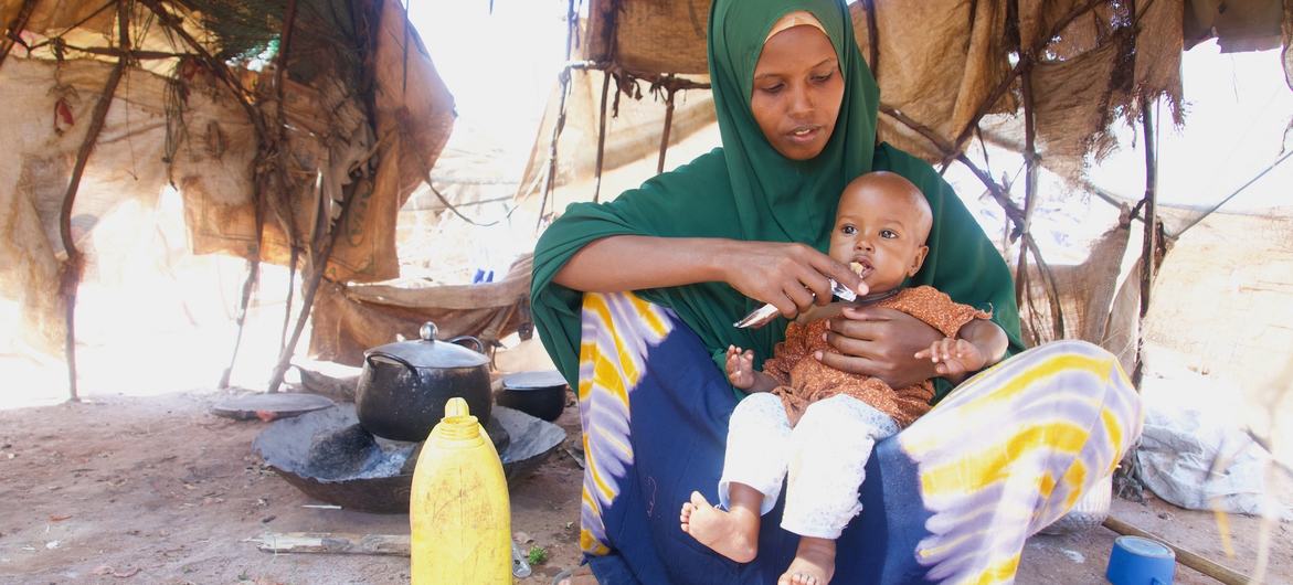 A woman with her one-year-old child who is being treated for malnutrition in Dollow, Somalia. An additional 4.4 million people across the country are at risk of falling into hunger and malnutrition.