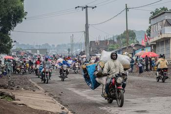 People displaced by the fighting in Goma flee the city.