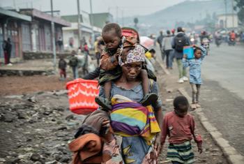 A woman walks through the streets with children in Goma in the eastern Democratic Republic of the Congo.