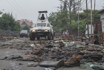 UN peacekeepers patrol Goma in the eastern DR Congo after the city is overrun by rebel forces. In the foreground, military uniforms and equipment have been abandoned on the road.