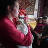 On 23 February 2022, a four-year-old girl and two-month-old baby are comforted by their parents after shelling by separatist forces in Novognativka, eastern Ukraine.
