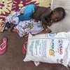 A young boy in Mozambique sleeps next to a bag of food aid donated by USAID and distributed by the UN’s World Food Programme.